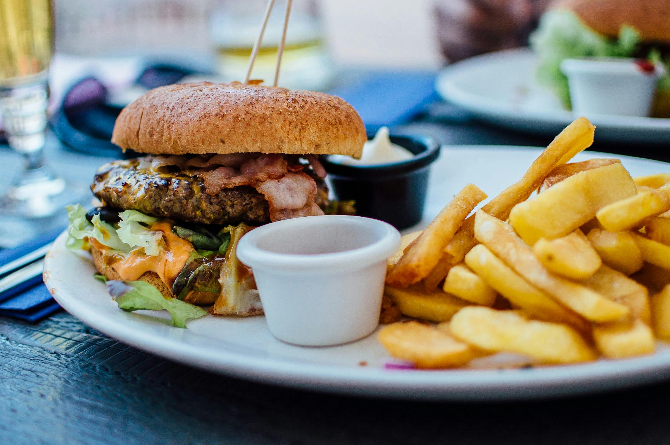 plate of big hamburger and fries